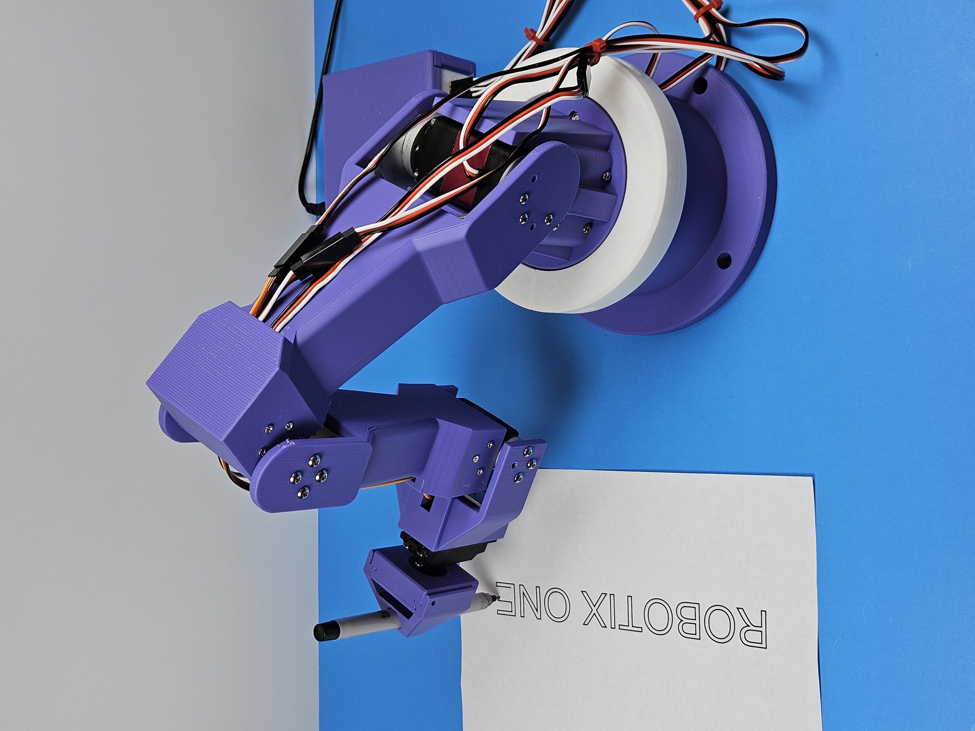 The arm writing ROBOTIX ONE