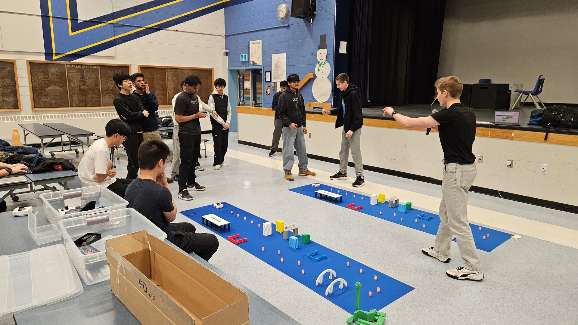 Anthony hosting the robot race beside the two tracks