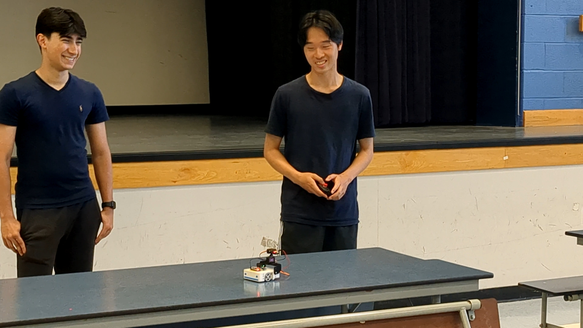 Two participants with a Stackr robot and a controller